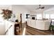Bright living room features fireplace, open floor plan, and view of dining area, creating a cozy atmosphere at 4820 S County Road 137, Bennett, CO 80102