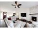 Relaxing living room features neutral colors, fireplace, and a large window offering plenty of natural light at 4820 S County Road 137, Bennett, CO 80102