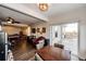 Living room with a dining area, hardwood floors, a ceiling fan, and sliding doors to the outside at 4820 S County Road 137, Bennett, CO 80102