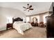 Spacious main bedroom featuring neutral tones, large windows with elegant sheer curtains, and a ceiling fan at 4820 S County Road 137, Bennett, CO 80102