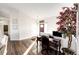 Cozy office nook features a vintage desk, comfortable chair, and ample natural light creating a productive workspace at 4820 S County Road 137, Bennett, CO 80102