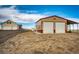 Spacious property featuring a home and a large metal outbuilding with multiple garage doors for ample storage at 4820 S County Road 137, Bennett, CO 80102