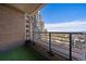 Relax on this spacious balcony overlooking a beautiful city view, complete with brick accents and artificial turf at 8100 E Union Ave # 1603, Denver, CO 80237