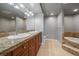 Bathroom featuring double sink vanity, a soaking tub and tiled flooring at 8100 E Union Ave # 1603, Denver, CO 80237