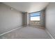Bright bedroom featuring neutral walls, plush carpet, and a large window with city views at 8100 E Union Ave # 1603, Denver, CO 80237
