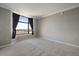 Bright bedroom featuring neutral walls, plush carpet, and a large window with city views at 8100 E Union Ave # 1603, Denver, CO 80237