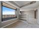 Bright bedroom featuring a balcony with a view and integrated shelving at 8100 E Union Ave # 1603, Denver, CO 80237