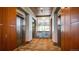 Hallway with elevators and a waterfall feature, with wood accents and custom carpet at 8100 E Union Ave # 1603, Denver, CO 80237