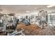 Well-equipped gym featuring cardio machines and weightlifting equipment, with large windows providing natural light and views at 8100 E Union Ave # 1603, Denver, CO 80237