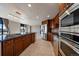 Gourmet kitchen featuring stainless steel appliances, granite countertops, and a central island with bar seating at 8100 E Union Ave # 1603, Denver, CO 80237