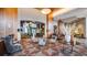 An elegant seating area with stylish chairs and tables in a sophisticated lobby, accented by wood paneling and mirrors at 8100 E Union Ave # 1603, Denver, CO 80237