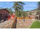 Backyard with a deck and wooded area at 3439 Burnham Dr, Kittredge, CO 80457