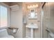 Bathroom featuring a pedestal sink, medicine cabinet, and towel rack with natural light at 3439 Burnham Dr, Kittredge, CO 80457