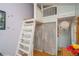 Bedroom with wood floors, closet, a loft and white staircase at 3439 Burnham Dr, Kittredge, CO 80457
