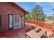 Outdoor deck with views, table and chairs at 3439 Burnham Dr, Kittredge, CO 80457