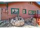 Home exterior featuring a stone well and wood siding at 3439 Burnham Dr, Kittredge, CO 80457