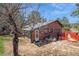 Exterior of cozy home with trees, and a deck at 3439 Burnham Dr, Kittredge, CO 80457
