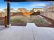 Large fenced backyard with grass and wood mulch, viewed from covered patio at 228 N Edge Cliff St, Castle Rock, CO 80104