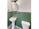 Bathroom with green wainscoting, a pedestal sink, and modern lighting at 228 N Edge Cliff St, Castle Rock, CO 80104