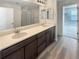 Modern bathroom with double sinks, vanity, and large mirror at 228 N Edge Cliff St, Castle Rock, CO 80104