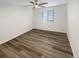 Neutral bedroom with a ceiling fan, window with blinds, and light-colored walls and plank flooring at 228 N Edge Cliff St, Castle Rock, CO 80104