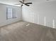 Neutral bedroom with a ceiling fan, carpet flooring and a large window with blinds for natural light at 228 N Edge Cliff St, Castle Rock, CO 80104