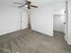 Neutral bedroom with a ceiling fan and carpeted flooring, featuring open doorway to a closet at 228 N Edge Cliff St, Castle Rock, CO 80104