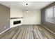 Bright and open living room with wood floors and a fireplace, ready for you to add your personal touches at 228 N Edge Cliff St, Castle Rock, CO 80104