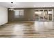 Spacious living room with modern light fixture and sliding glass doors to the backyard at 228 N Edge Cliff St, Castle Rock, CO 80104