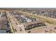 Aerial view of new neighborhood with modern townhomes, street parking, and landscaping at 16251 E 47Th Pl, Denver, CO 80239