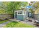 Charming backyard with green grass, a fire pit, and a quaint shed at 269 Delaware St, Denver, CO 80223