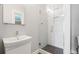 Modern bathroom with a glass shower, white vanity, and grey walls at 269 Delaware St, Denver, CO 80223