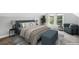 Comfortable bedroom with a plush bed, soft lighting, and a cozy seating area by the window at 269 Delaware St, Denver, CO 80223