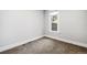 Corner bedroom with neutral carpet, white trim and a bright window at 269 Delaware St, Denver, CO 80223