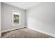 Carpeted bedroom with white trim and large bright window at 269 Delaware St, Denver, CO 80223