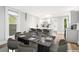 Dining room open to a contemporary kitchen with stainless steel appliances and bar stool seating at 269 Delaware St, Denver, CO 80223