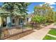 A charming blue home features wrought iron fencing and well-manicured landscaping for enhanced curb appeal at 269 Delaware St, Denver, CO 80223
