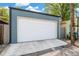 This property has a well-maintained, two car garage with a concrete driveway and painted blue siding at 269 Delaware St, Denver, CO 80223