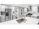 Bright kitchen with stainless steel appliances, white countertops and ample cabinetry at 269 Delaware St, Denver, CO 80223