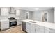 Modern kitchen with stainless steel appliances, an island with white countertop and wood flooring at 269 Delaware St, Denver, CO 80223