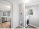 Efficient laundry area with stacked washer and dryer, window, and view of kitchen at 269 Delaware St, Denver, CO 80223