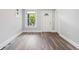 Sunlit living room with windows, stylish flooring and a view of the entry door at 269 Delaware St, Denver, CO 80223