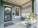 Welcoming porch with painted brick, flower pot, and stylish black door at 269 Delaware St, Denver, CO 80223