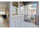 A balcony with gray wood and black metal trim faces another home and has open access to the kitchen at 6834 Merseyside Ln, Castle Pines, CO 80108