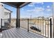 A spacious covered balcony with wood-look decking and black metal railings overlooks the street at 6834 Merseyside Ln, Castle Pines, CO 80108
