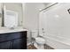 Bathroom has a vanity with dark cabinetry, white countertops, and a shower-tub combo at 6834 Merseyside Ln, Castle Pines, CO 80108