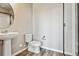 Cozy bathroom featuring a modern sink, toilet, and glass-enclosed shower at 6834 Merseyside Ln, Castle Pines, CO 80108