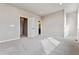 Bright bedroom featuring neutral walls, plush carpet, and convenient ensuite bathroom access at 6834 Merseyside Ln, Castle Pines, CO 80108