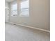 This bedroom is carpeted with light gray walls, big windows, and a door to enter at 6834 Merseyside Ln, Castle Pines, CO 80108