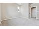 Bedroom showcases neutral carpet, light gray walls, and a white interior door at 6834 Merseyside Ln, Castle Pines, CO 80108